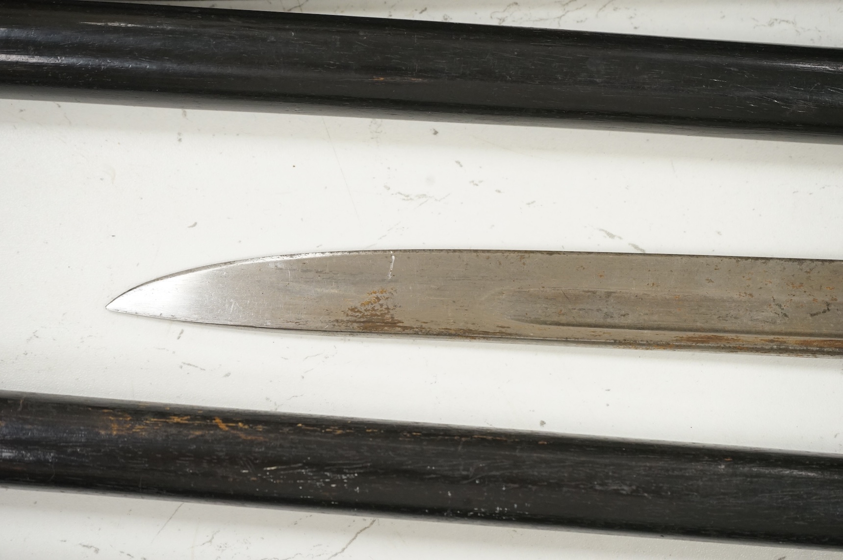 Three early 20th century Indonesian bone overlaid sword sticks and a bayonet, largest 92cm in length